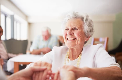 Lady happy dancing in care home