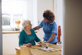 Happy resident talking with a caregiver